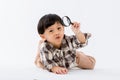 Child holding magnifying glass on white background. Boy with a magnifying glass in studio. Royalty Free Stock Photo