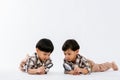 Child holding magnifying glass on white background. Boy with a magnifying glass in studio. Royalty Free Stock Photo