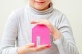 Child is holding paper pink house Royalty Free Stock Photo