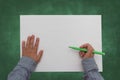 Child holding pen on blank sheet of paper Royalty Free Stock Photo