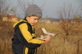 Child holding plane model