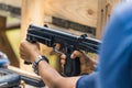 Child holding polish PM Rak submachine gun. Target practice. Firearm training at outdoor shooting range. Horiozntal shot Royalty Free Stock Photo