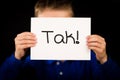 Child holding sign with Danish word Tak - Thank You Royalty Free Stock Photo