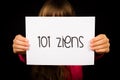 Child holding sign with Dutch words Tot Ziens - Goodbye