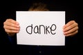 Child holding sign with German word Danke - Thank You