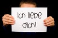 Child holding sign with German words Ich liebe Dich - I Love You