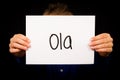 Child holding sign with Portuguese word Ola - Hello Royalty Free Stock Photo