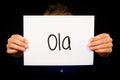 Child holding sign with Portuguese word Ola - Hello Royalty Free Stock Photo