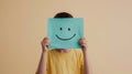 Child Holding Smiley Face Paper.AI generated image Royalty Free Stock Photo