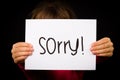 Child holding Sorry sign Royalty Free Stock Photo