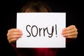 Child holding Sorry sign Royalty Free Stock Photo