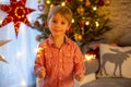 Child holding sparkler at home at New Years Eve, enjoying happy evening