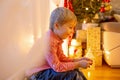 Child holding sparkler at home at New Years Eve, enjoying happy evening