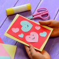 Child is holding a Valentines day greeting card in his hands. Small child is showing a Valentines day greeting card Royalty Free Stock Photo