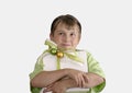 Child holding a wrapped present and thoughtfully looking up