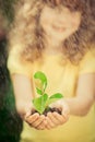 Child holding young plant