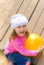 Child holds a ball