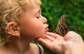 A child holds a beautiful butterfly. Selective focus.