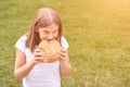 Child holds and bite round bread. Healthy food