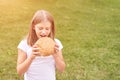 Child holds and bite round bread. Healthy food