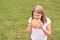Child holds and bite round bread. Healthy food