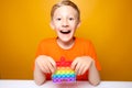 Child holds a colorful silicone anti stress toy balls that burst in front of him Royalty Free Stock Photo