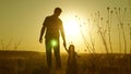 Child holds father`s hand. dad and baby are resting in the park. child plays with his father. little daughter and dad Royalty Free Stock Photo