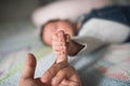 Child holds finger. Baby hand gently holding adult`s finger Royalty Free Stock Photo