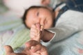 Child holds finger. Baby hand gently holding adult`s finger Royalty Free Stock Photo