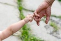 Child holds the finger of a hand