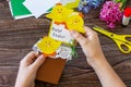 Child holds a gift postcard happy easter chickens toy on a wooden table. Handmade. Project of childrens creativity. Royalty Free Stock Photo