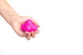 The child holds in his hand a magenta pink sports ball reaction