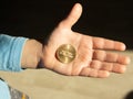 a child holds a McDonald`s coin in his hand 30 years