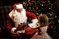 A child holds a medical mask behind his back and wants to present it to Santa Hygiene in an epidemic pandemy Royalty Free Stock Photo