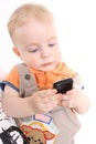 The child holds a mobile phone in hands