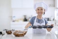 Child holds mold with chocolate dough