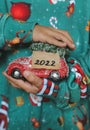 A child holds a New Year`s car in his hands with the year 2022 and dreams of a new toy