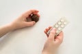 Child holds in one hand a package of pills and chocolate candy in the second hand Royalty Free Stock Photo