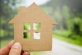 Child holds paper house. Loan for new house theme. Financial operations.