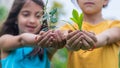 The child holds the plant and soil in his hands. Selective focus. Royalty Free Stock Photo