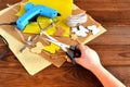 Child holds the scissors in his hands and does summer crafts with felt butterflies and flowers