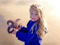 Child holds Seastar Star Fish on Sandy Beach Royalty Free Stock Photo