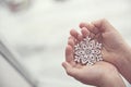 Child holds a snowflake