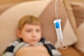 The child at home lies under a dropper, injections to the child with an infectious disease