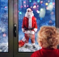 Child observes Santa Claus through the windows