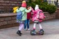 Child on hover board. Kids riding scooter in summer park. Balance board for children. Electric self balancing scooter on city Royalty Free Stock Photo