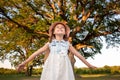 Child and a huge tree in the forest. old oak and a little girl Royalty Free Stock Photo