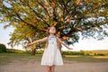 Child and a huge tree in the forest. old oak and a little girl Royalty Free Stock Photo