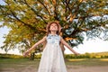Child and a huge tree in the forest. old oak and a little girl Royalty Free Stock Photo