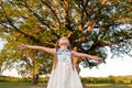 Child and a huge tree in the forest. old oak and a little girl Royalty Free Stock Photo